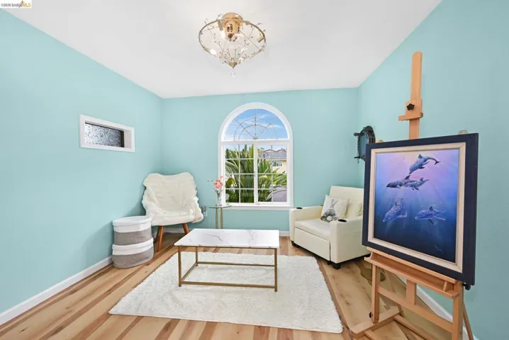 Sitting room featuring wood finished floors and suspended lighting