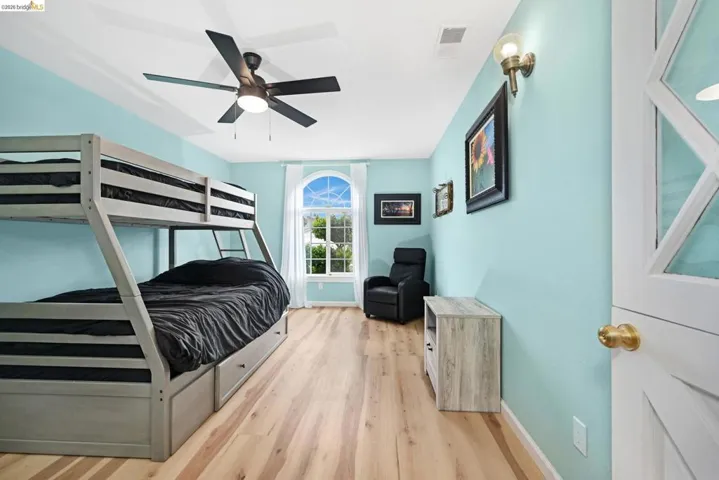 Bedroom featuring light wood-type flooring and ceiling fan