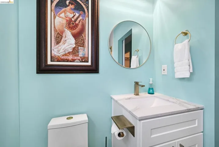 Half bathroom featuring toilet and vanity
