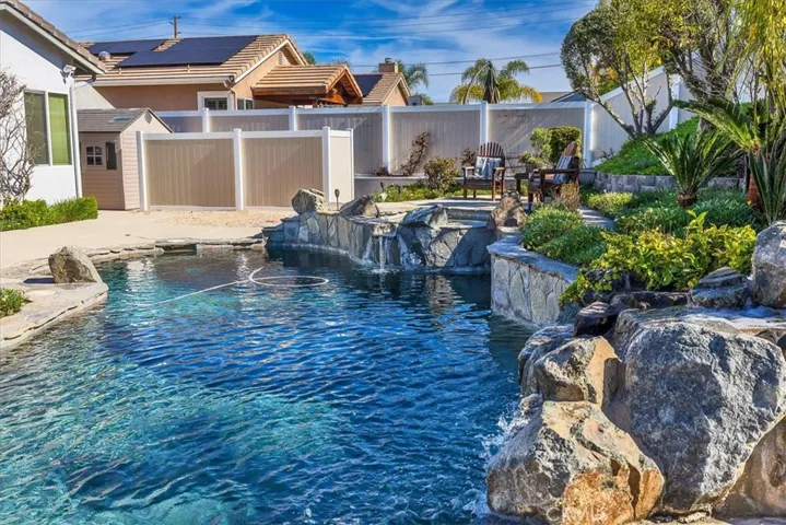 STUNNING SALT WATER POOL AND RAISED SPA WITH PEBBLE TEK SURFACE WITH AUTHENTIC STONE WATERFALL!!