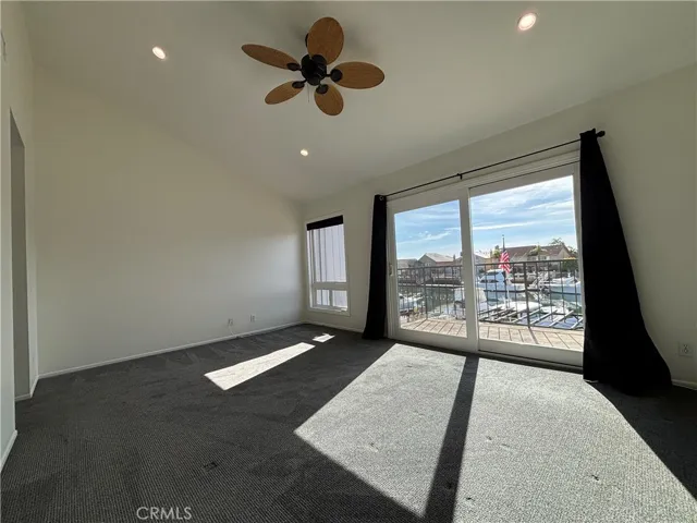 Primary bedroom with balcony overlooking the water.