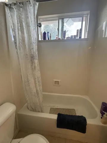 Full bathroom featuring toilet and shower / bath combo