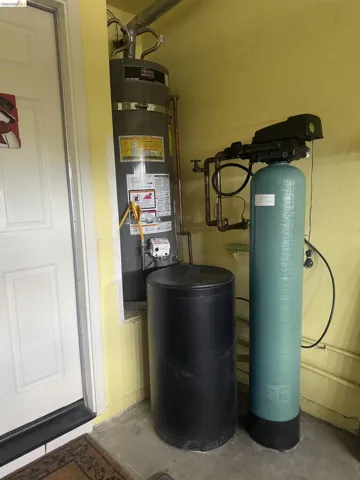 Water heater system with an adjacent water softener unit