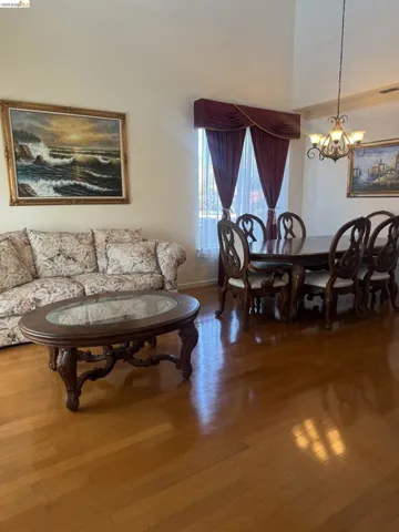 Hardwood flooring extending throughout the living and dining areas