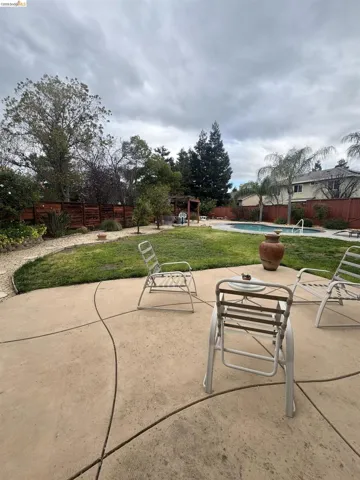 Fenced backyard with a patio