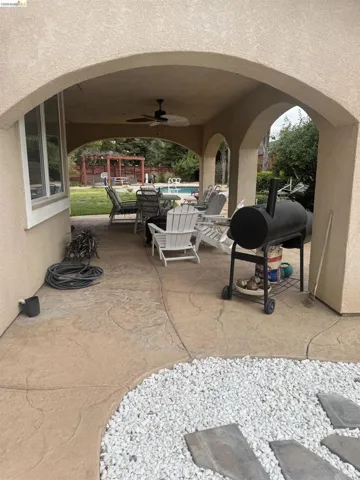 View of patio / terrace with ceiling fan, an outdoor pool, grilling area, and outdoor dining area