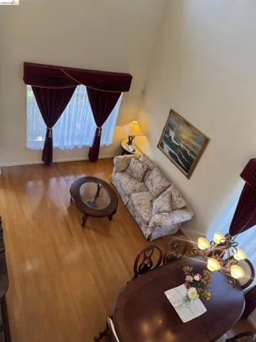 High ceilings create an airy atmosphere, complemented by light wood-finish flooring