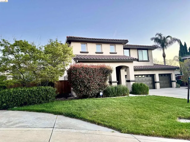 Mediterranean / spanish-style house featuring stucco siding, a tiled roof, concrete driveway, and a garage