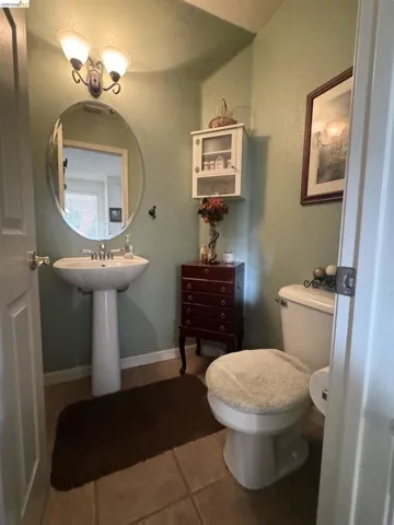 Bathroom featuring a textured wall and tile patterned flooring