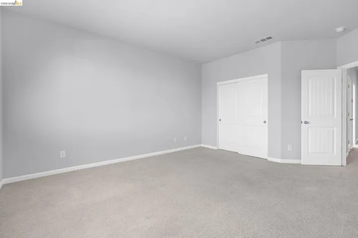 Unfurnished bedroom featuring carpet flooring and a closet