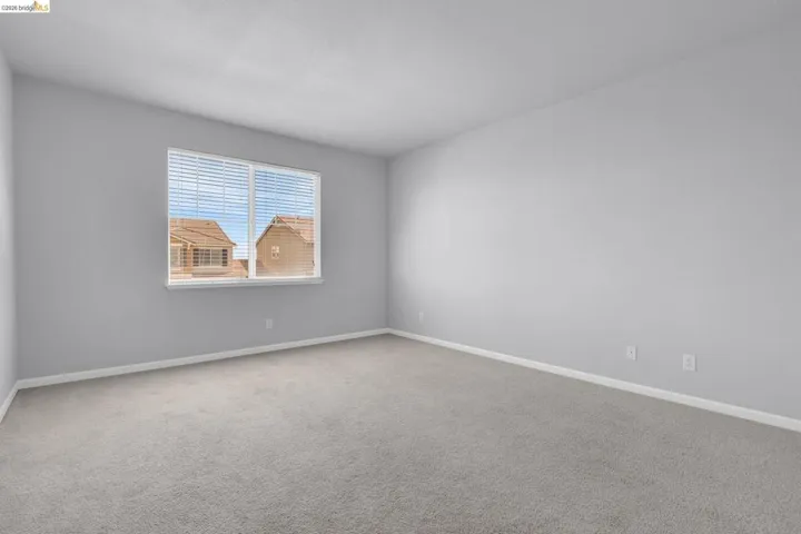 Unfurnished room featuring carpet flooring and baseboards