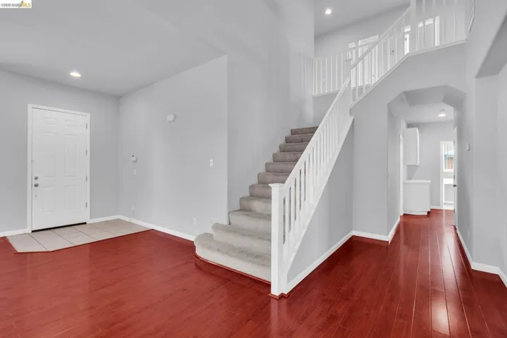 Entryway featuring recessed lighting, a high ceiling, and dark wood finished floors