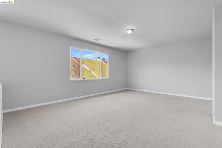 Unfurnished room with light carpet and baseboards