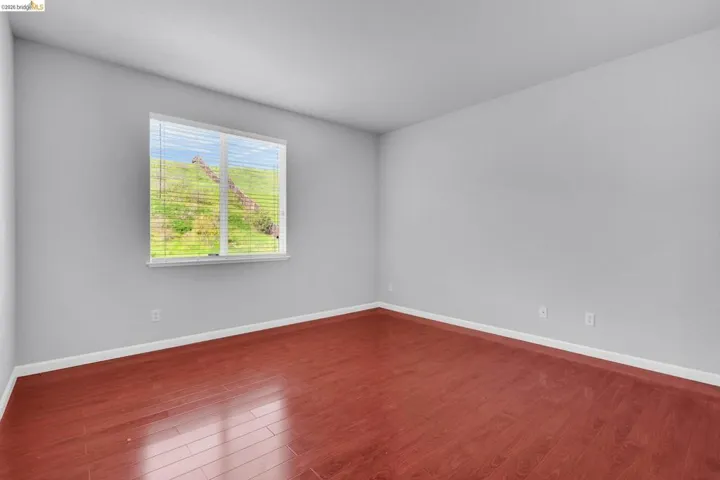 Spare room with dark wood-style flooring