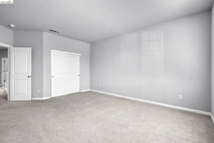 Unfurnished bedroom with a closet and carpet floors