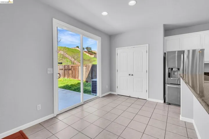 Unfurnished dining area featuring light tile patterned floors and recessed lighting