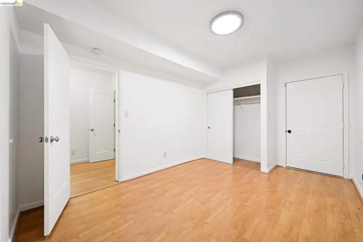 Unfurnished bedroom with a closet and light wood-style flooring