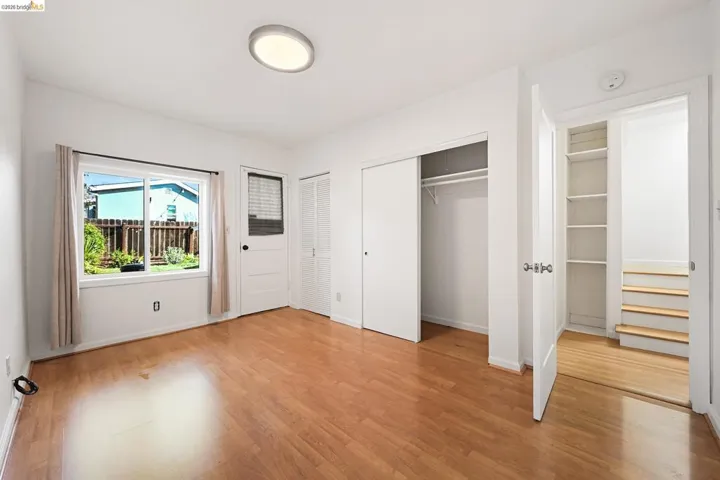 Unfurnished bedroom featuring two closets and light wood finished floors