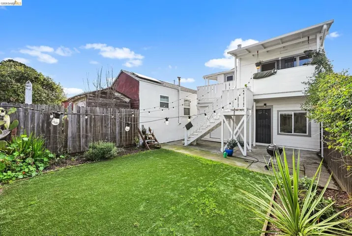 Rear view of house featuring a balcony and a patio area