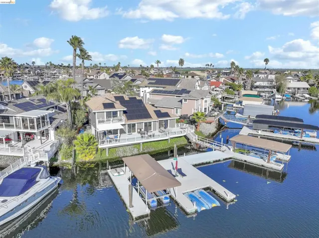 Aerial perspective of suburban area featuring a nearby body of water
