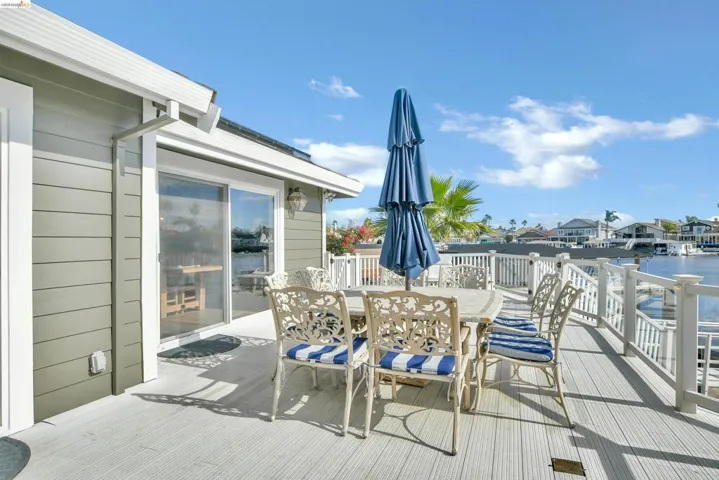 Wooden terrace featuring outdoor dining space and a residential view