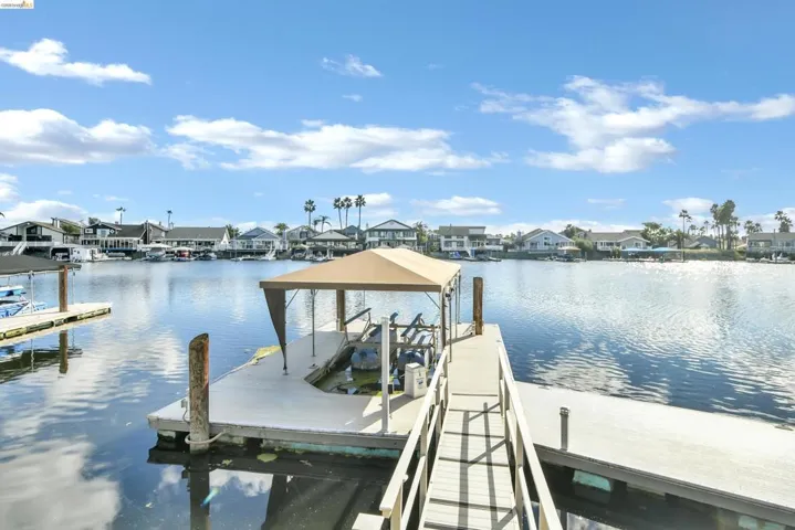 Dock featuring a residential view and a water view