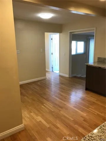 Kitchen Area- View towards backdoor + living room