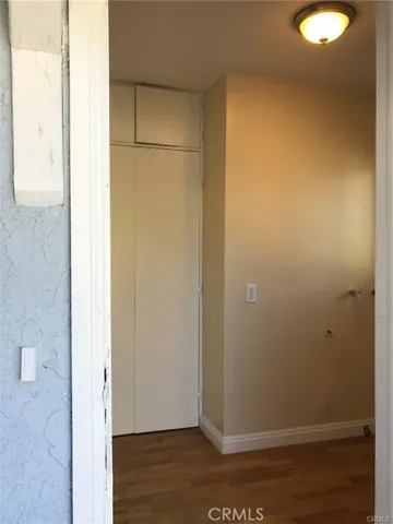 backdoor entry, laundry area, and storage cabinets