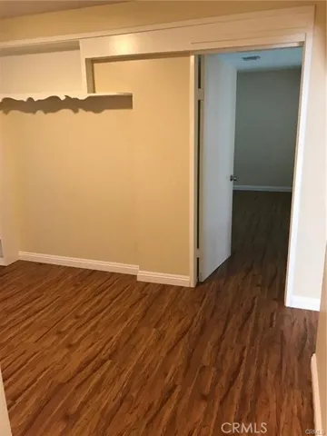 Hallway behind kitchen to 3 more bathrooms & full bath