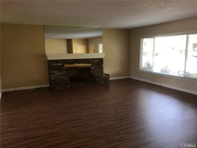 living room with fireplace (front door entrance)
