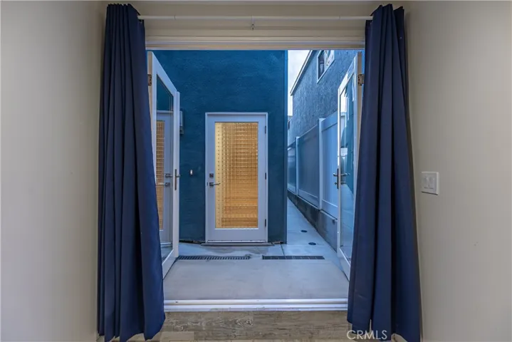 1st floor French doors leading out to the 4 car garage area and #2 House 419 Balboa Blvd, Stairs are through the door.