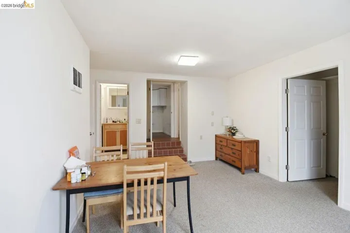 home office with light carpet and baseboards