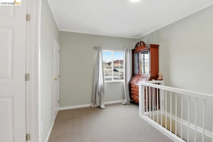 unfurnished bedroom with light carpet and ornamental molding