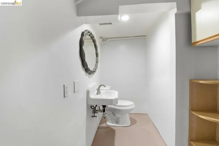 half bath featuring toilet and a sink