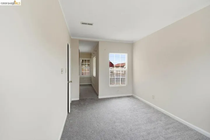 empty room featuring light carpet and ornamental molding