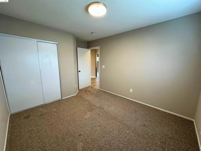 Unfurnished bedroom with carpet flooring and a closet