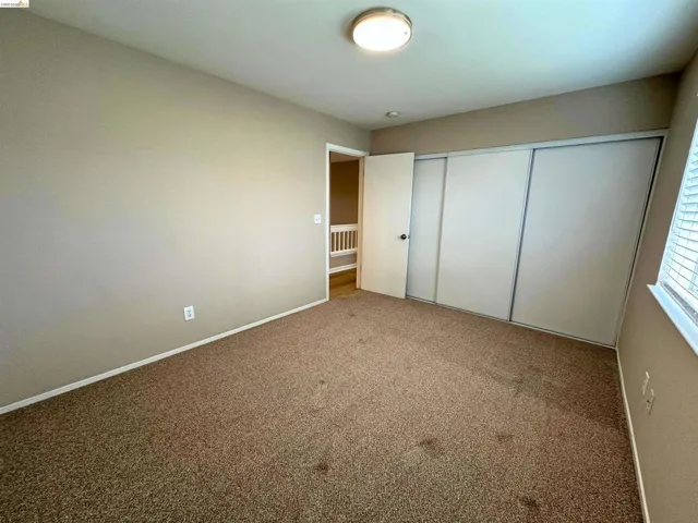Unfurnished bedroom with a closet and carpet floors