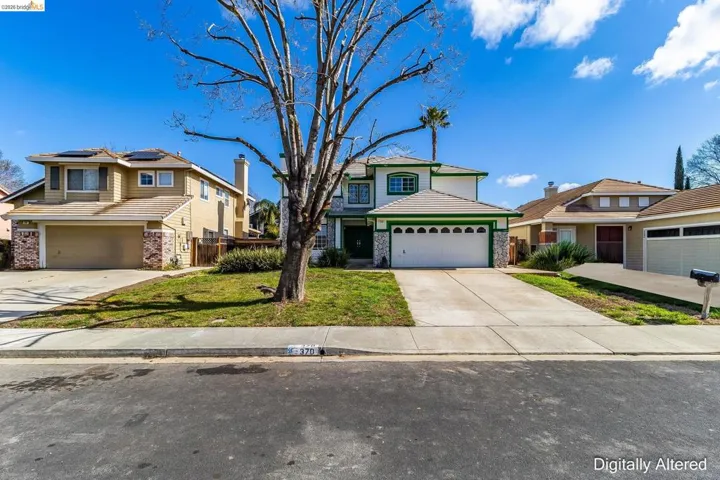 Traditional home with concrete driveway, a garage, and brick siding