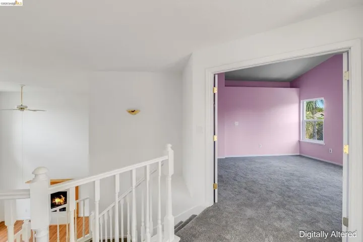 Hallway featuring an upstairs landing and carpet floors