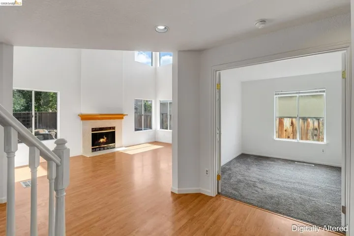 Unfurnished living room featuring a fireplace with flush hearth, light wood-style floors, and recessed lighting