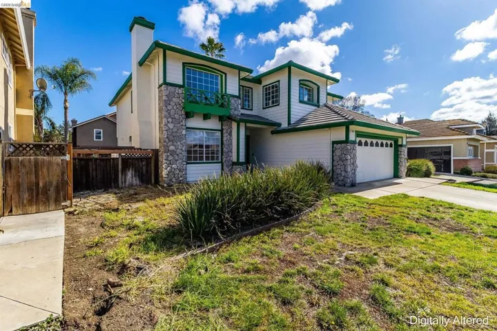 Traditional-style house featuring stone siding, a chimney, a garage, and concrete driveway