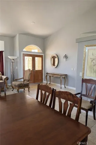 Dining Room with front door entry - AI enhanced to remove items off table