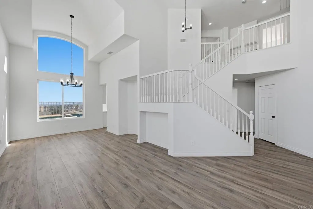 Living room/Dining room combo has gorgeous pecan toned wide plank lvp & a picture window of the lake