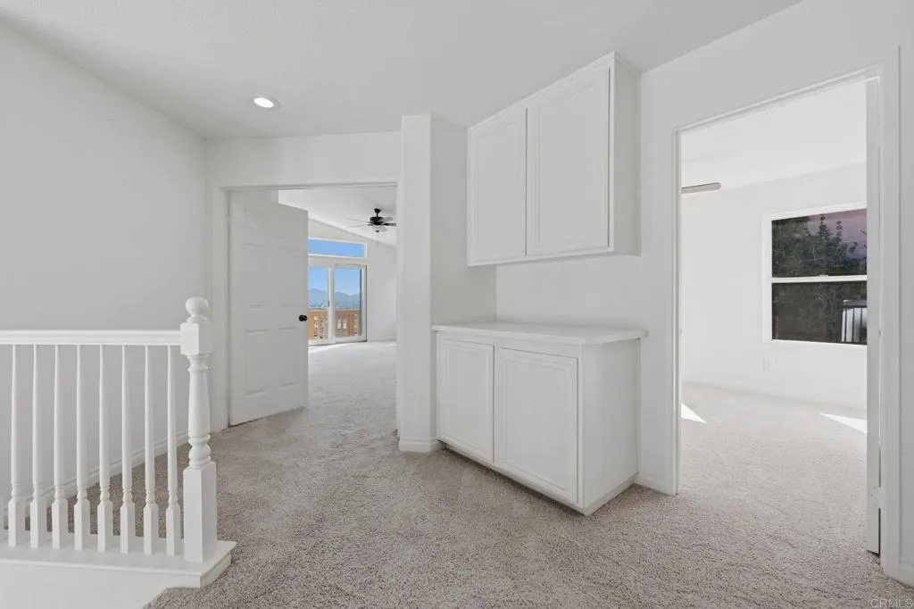 Hallway has built ins at the landing/hall area, leading to two bedrooms