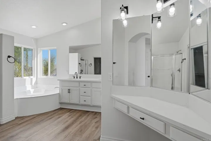 Master bath with separate shower & corner lake view bathtub...all freshly remodeled