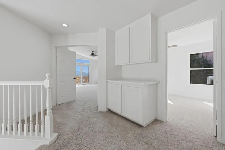 Hallway has built ins at the landing/hall area, leading to two bedrooms
