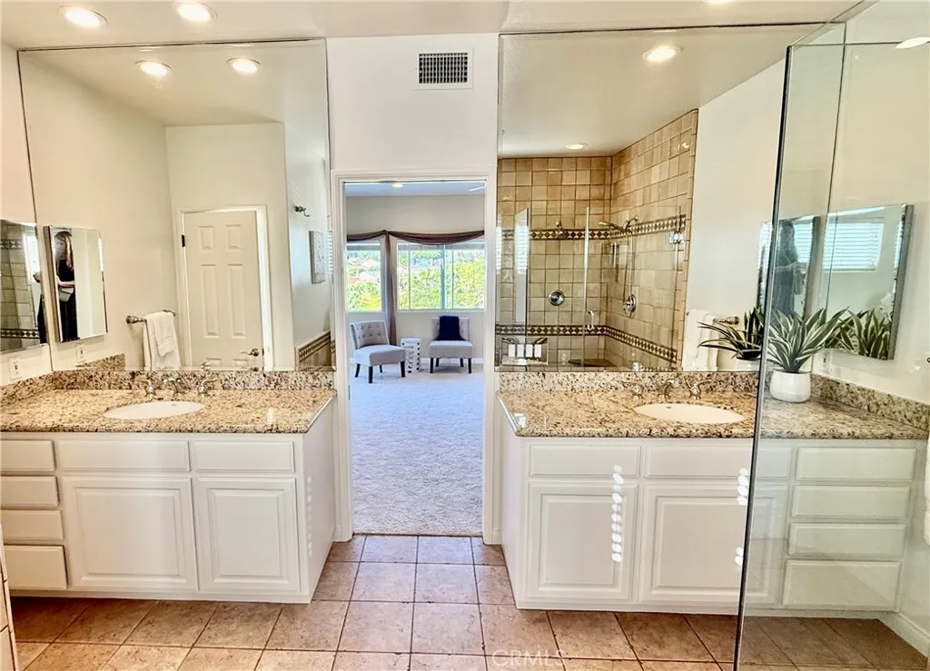Dual vanities with granite counters and laundry shoot to downstrairs
