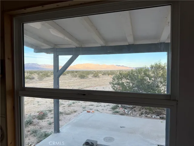 The view across the porch to the Sheephole Mountains.