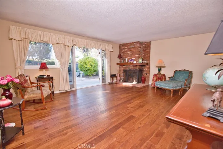 Beautiful wood-burning fireplace and French doors with sidelights leading out to the backyard