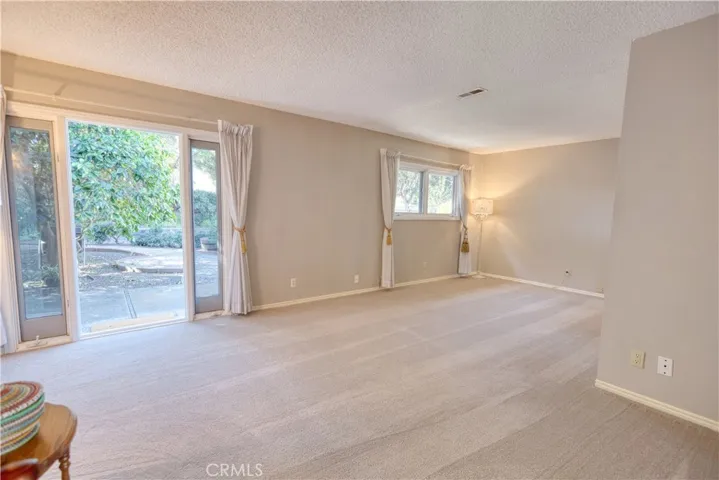 Expanded primary bedroom with French door and sidelight windows.